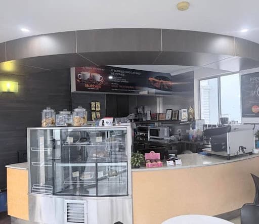 The Bubbles cafe counter with the cake display and coffee machine