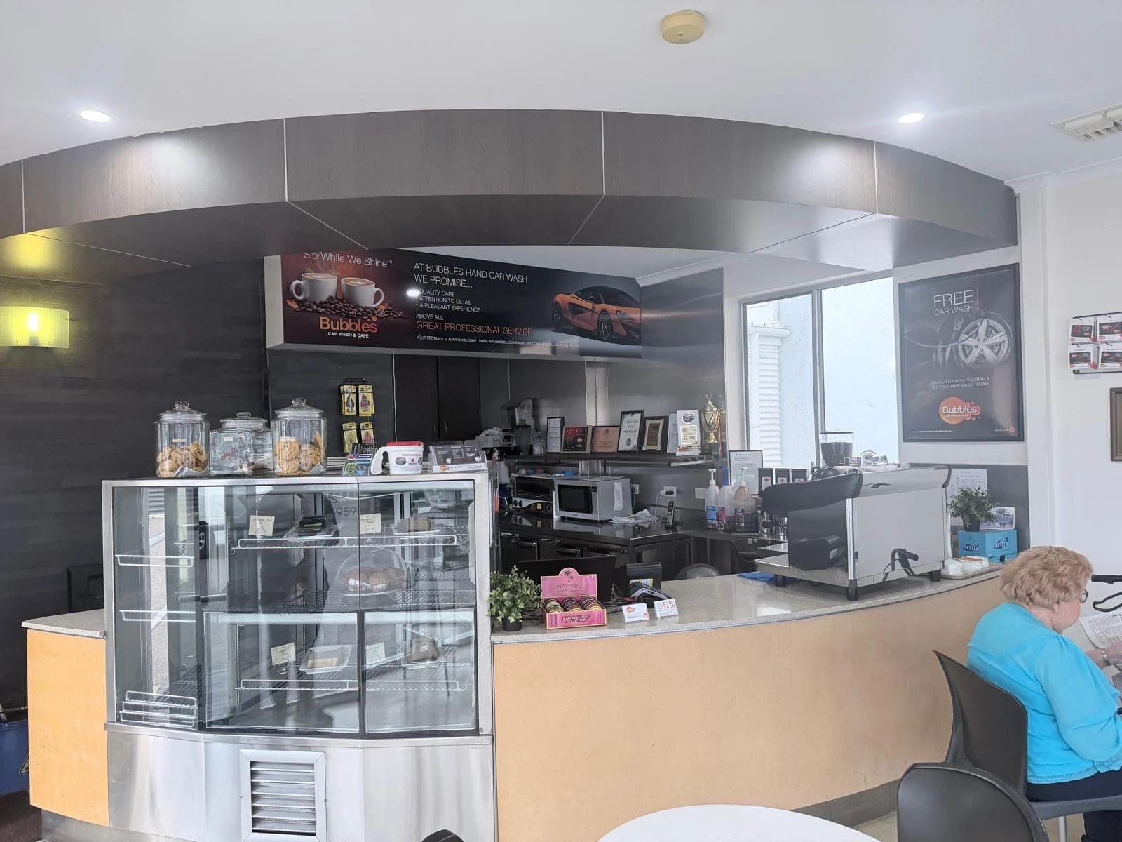 The Bubbles cafe counter with the cake display and coffee machine